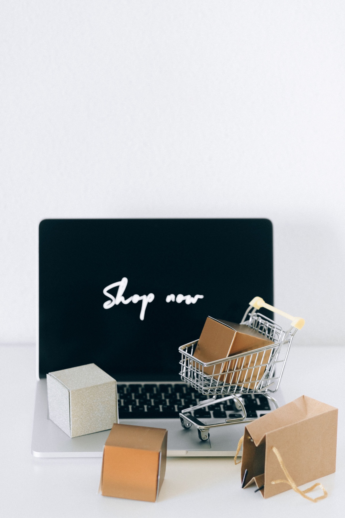 Online shopping display with a laptop, miniature cart and parcels